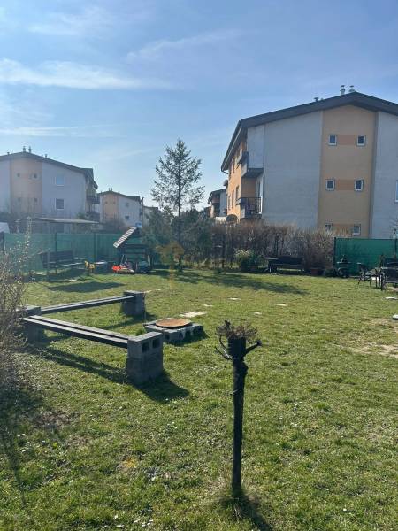 Grass area with benches and apartment buildings on M.R.Štefánika Street, Most pri Bratislave.