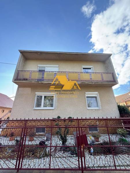 A family house in Tvrdošovce on Tvrdošovce Street with a balcony and a front garden behind a fence.