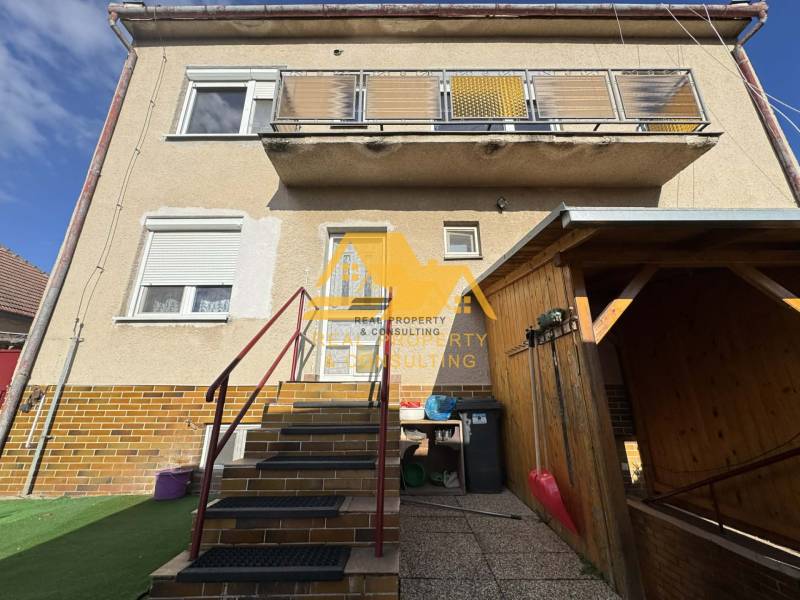 Family house in Tvrdošovce on Tvrdošovce street with an outdoor staircase and a balcony.