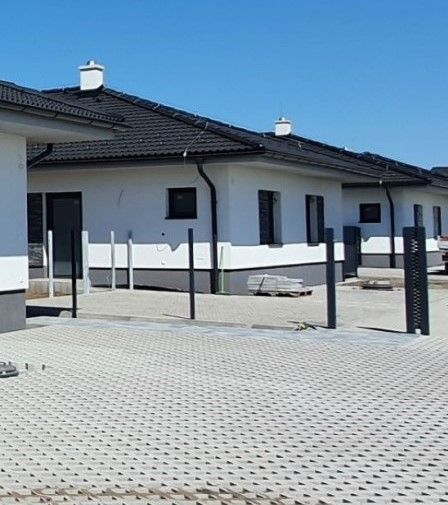 A family house on Leknová Street in Láb with a pitched roof and a paved driveway.