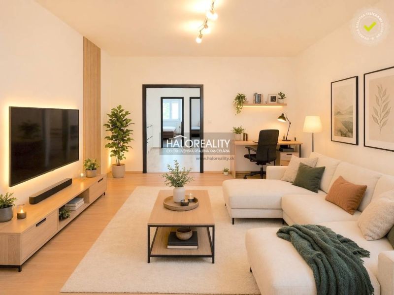 Living room with wood-decor flooring and a comfortable sofa in a four-room apartment.