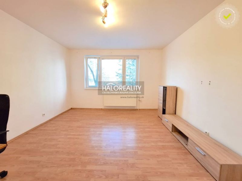 Living room with light walls and a wooden decor floor in a 4-room apartment.