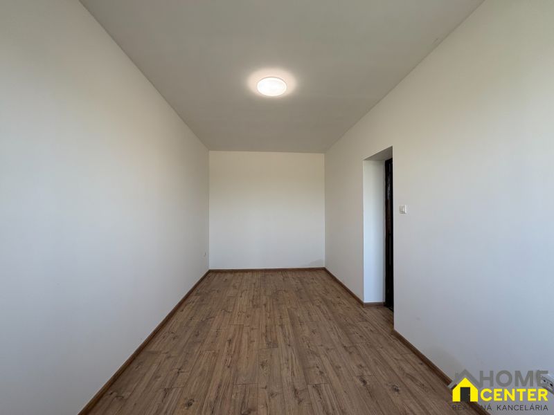 A family house with white walls and a wooden decor floor.