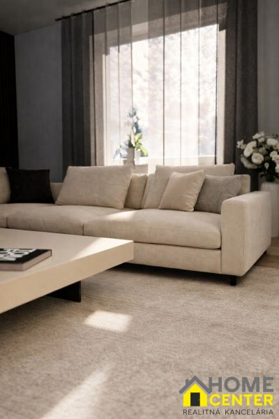 A bright living room with a beige sofa and a coffee table in a family house.