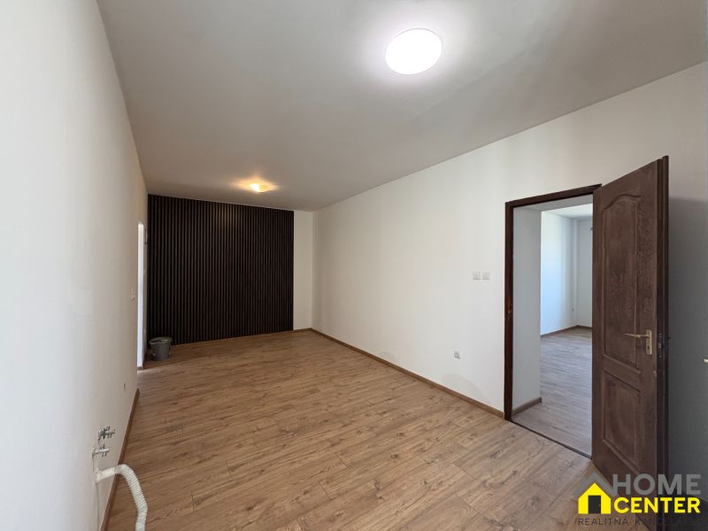 Interior of a family house with a wooden decor floor and white walls.