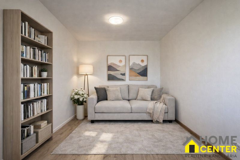 Living room in a family house with a sofa, bookshelf, and wooden decor flooring.