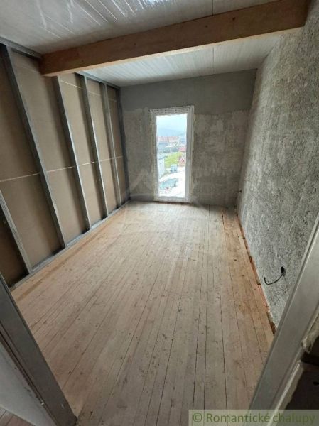 A room in a cottage with a wooden decor floor.