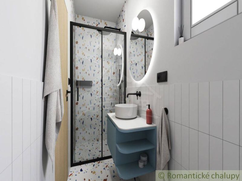 A bathroom in a cottage with a shower and terrazzo tiles on the walls.