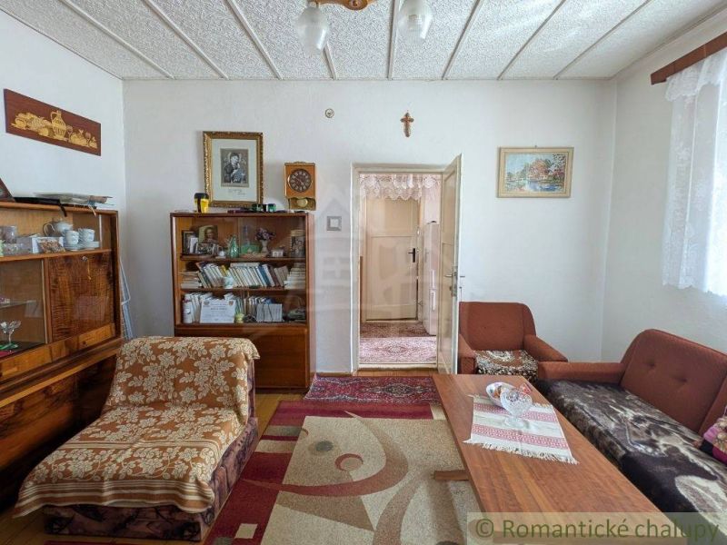 Living room in a family house with furniture and decorations, floor with wooden decor.