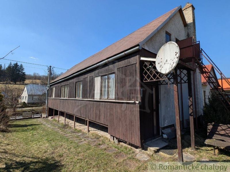 A family house in Kalinovo with a gable roof, wooden cladding, and a satellite dish.