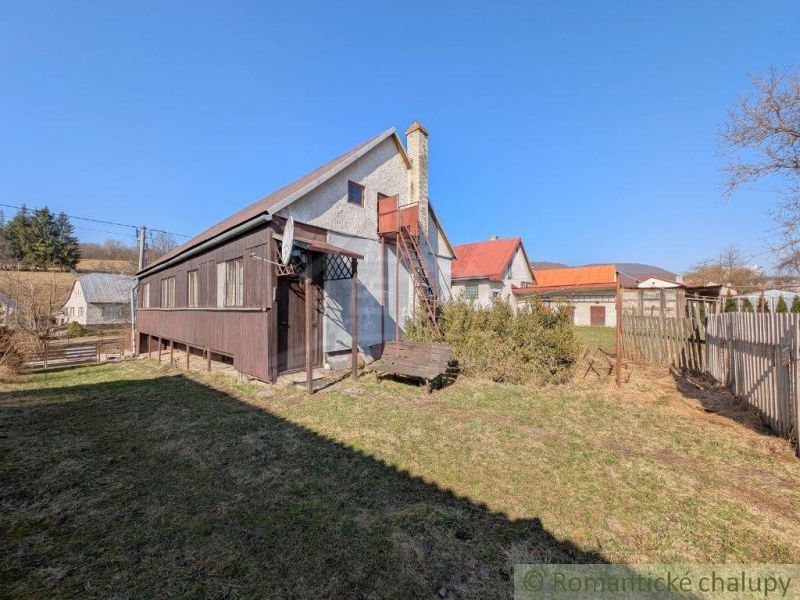 A family house in Kalinovo with a veranda and a hilly background.