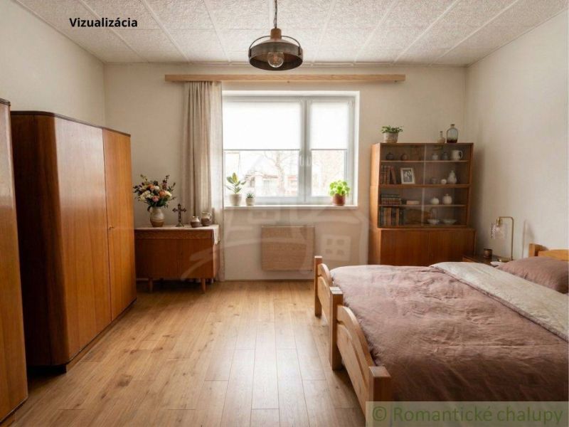 A bedroom in a family house with wooden decor on the floor, furniture, and decorations.