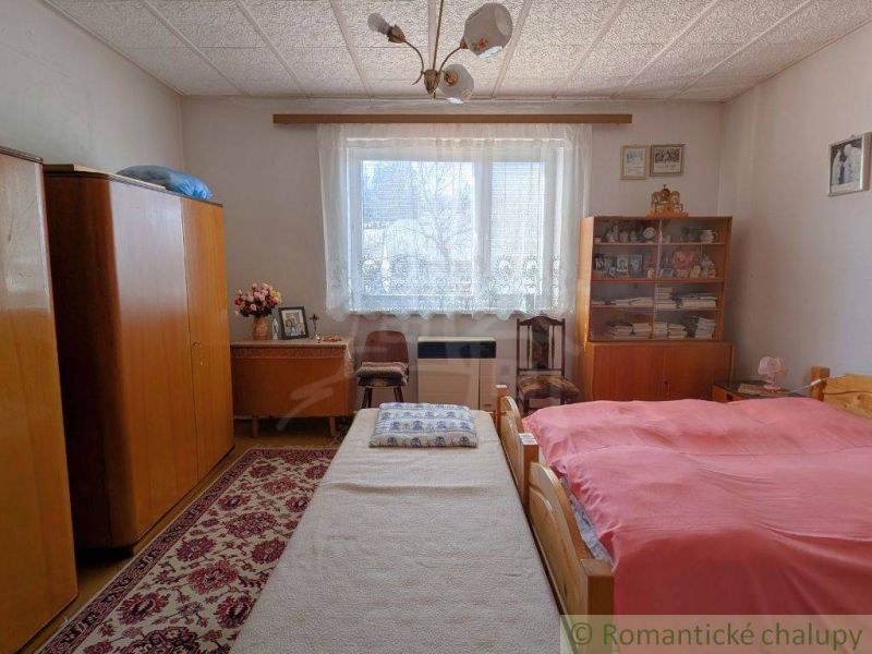 Bedroom in a family house with carpets, wardrobes, and decorative floral motif.
