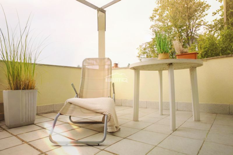 The balcony of a 5 or more room apartment in Rajecké Teplice with plants and furniture.