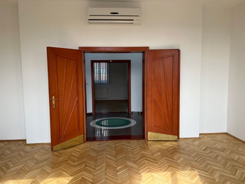On Štefánikova Street, spacious offices with parquet floors and wooden doors.