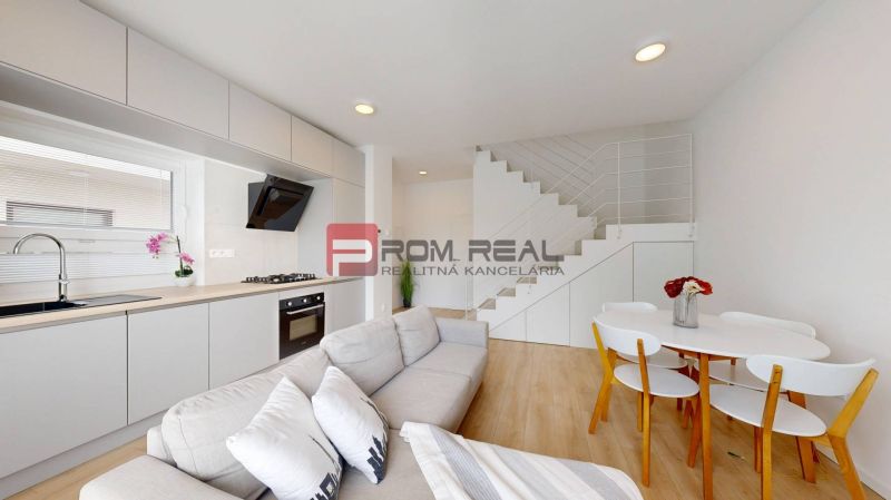 Kitchen and living room in a 3-room apartment with a wooden decor floor.
