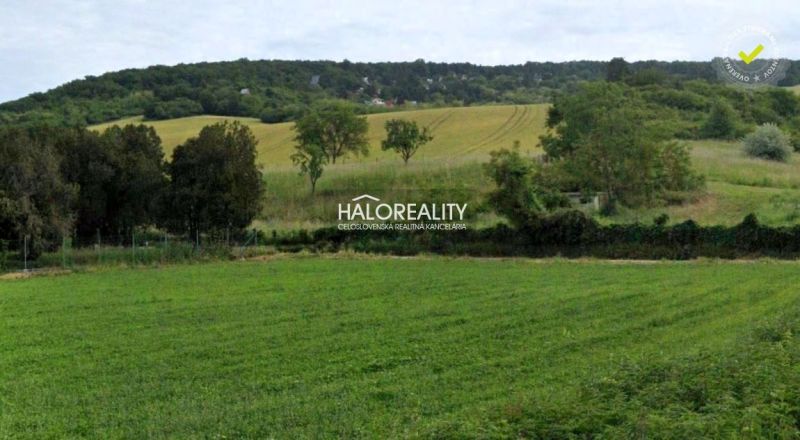 Fertile fields and hills near Hlohovec, surrounded by greenery in gardens and forests.