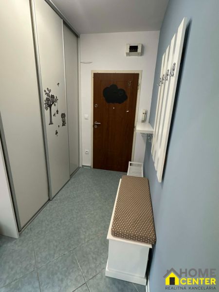Hallway in a two-room apartment with a wardrobe and a bench with a cushion.