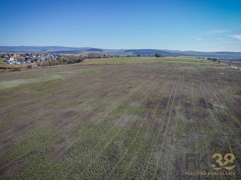 Extensive residential plots in Mlynica, visible vast nature and nearby dwellings.