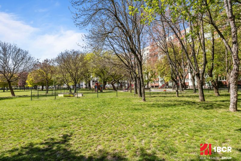 A park with a grassy area and trees in Bratislava - Podunajské Biskupice, on Estónska Street.