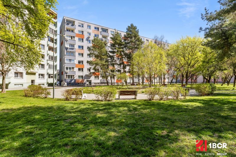 An apartment building surrounded by a green park in Bratislava - Podunajské Biskupice on Estónska Street.