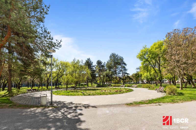 A park with benches and trees on Estónska Street in Bratislava - Podunajské Biskupice.