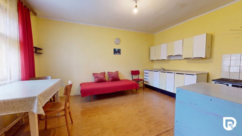A room in a family house with a kitchen unit and a wooden decor floor.