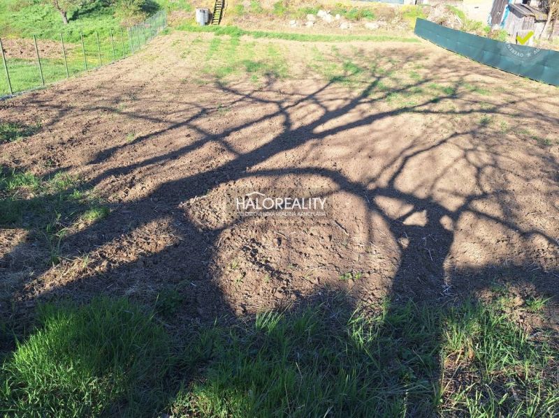 Residential plots in Záhorce with visible tree shadows and grassy edges.