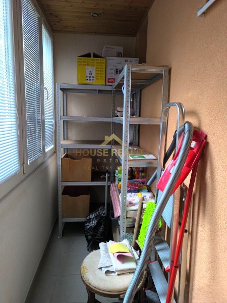 Storage space in a 3-room apartment with shelves and cleaning supplies.