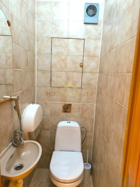 Bathroom with toilet and sink in a 3-room apartment.