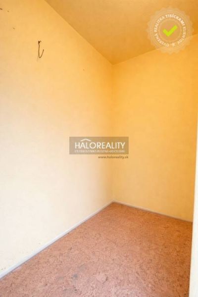 A small room with a wooden decor floor and light-colored walls.