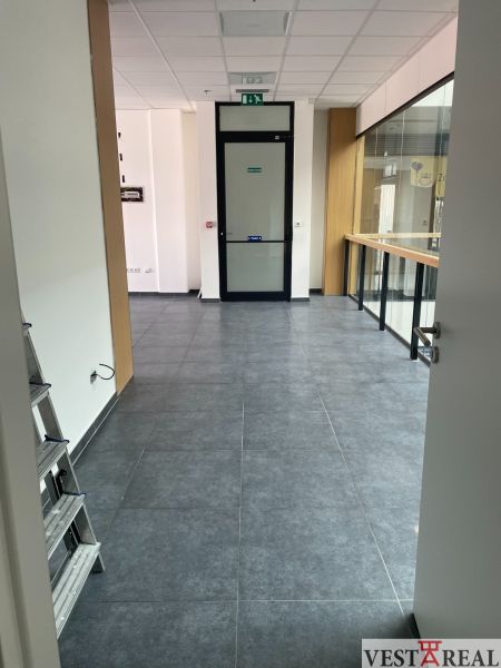 Commercial spaces with tiles and glass, suitable for various purposes.