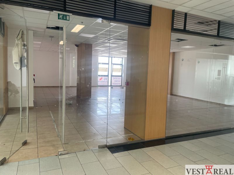Glass door-inspired commercial spaces with light ceramic tiles.