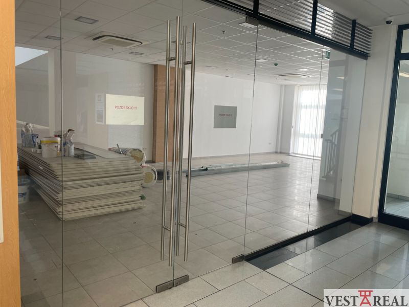 Glazed commercial spaces with tiles and equipment.