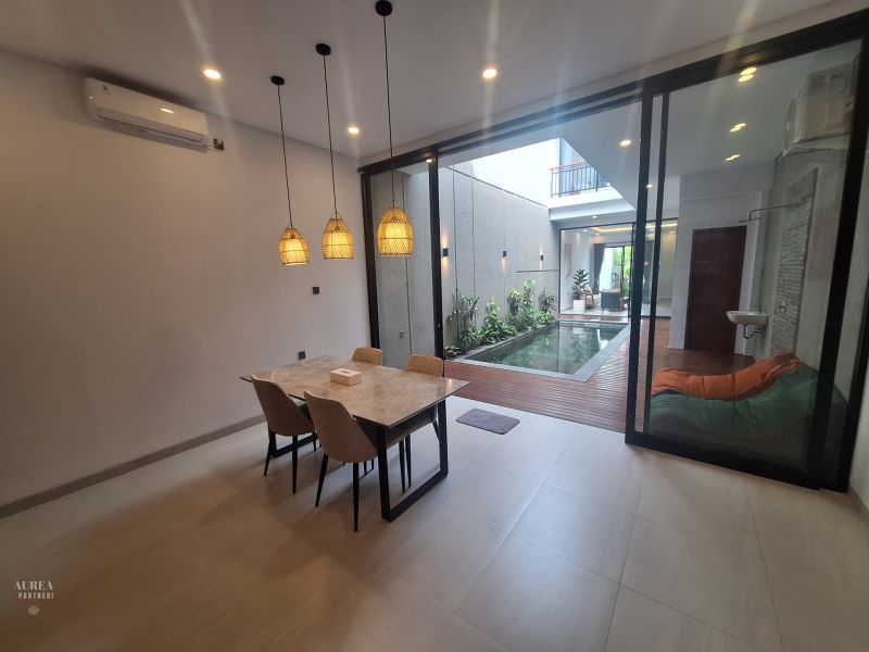Dining area in the villa with a pleasant view of the pool and terrace.