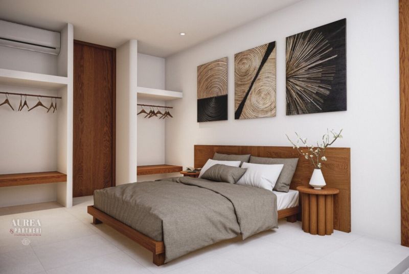 Design of a villa bedroom with art on the wall and a wooden decor floor.
