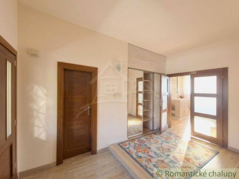 Interior of a family house with carpet decor and the presence of cabinets and doors.