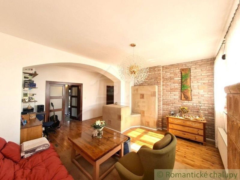 Living room of a family house with a wooden decor floor and a brick wall.