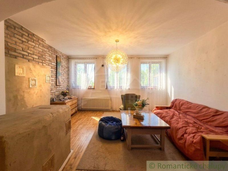 Living room in a family house with a brick wall and a wooden decor floor.