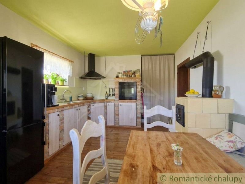 A kitchen in a family house with a wooden floor decor and a traditional stove.