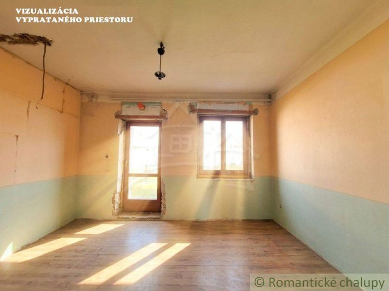 A room in a family house with a wooden decor floor, without furniture.