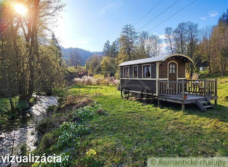 In the gardens around Ľubietová, a wooden caravan by the creek in a picturesque natural setting.