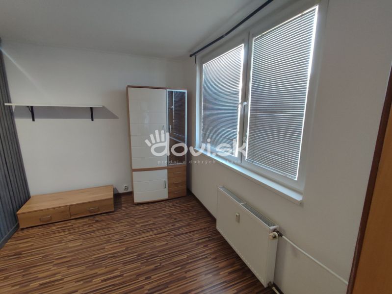 1-bedroom apartment with a wooden decor floor, furniture, and a large window with blinds.