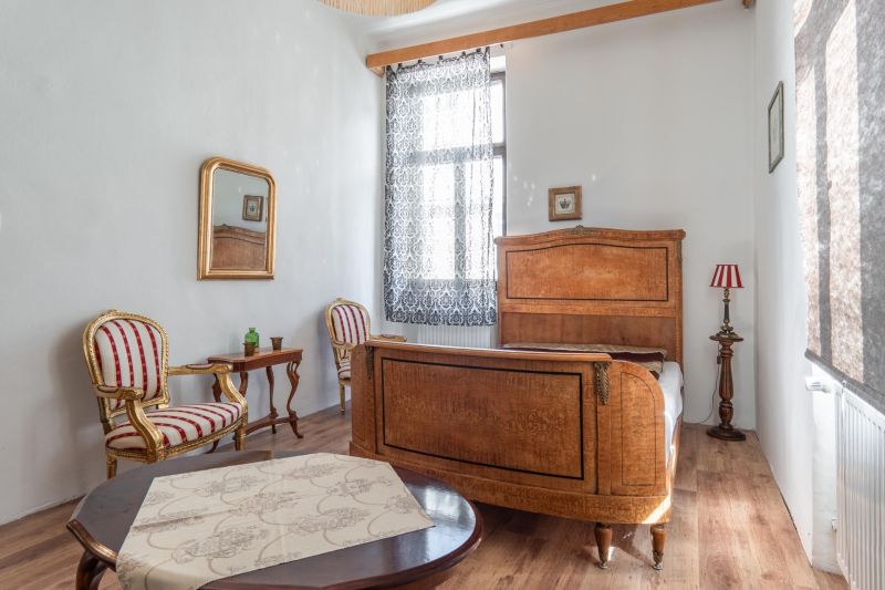 A room in a cottage with wooden decor, classic furniture, and subtle accessories.