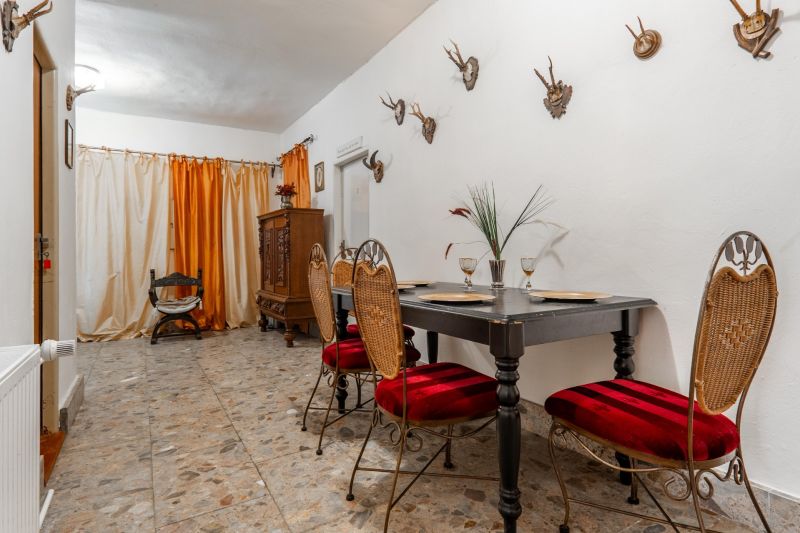 Dining area in a cabin with trophies on the wall and elegant furniture.