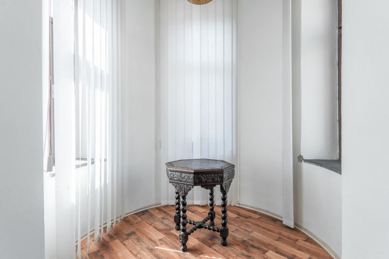 A small table with ornaments on the floor with a wooden decor in the cabin.