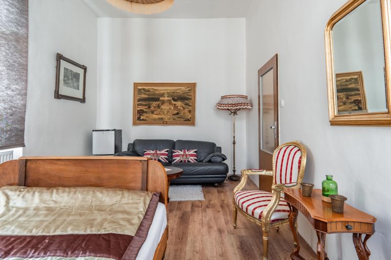 Bright room in a cottage with historical furniture and a wooden decor floor.