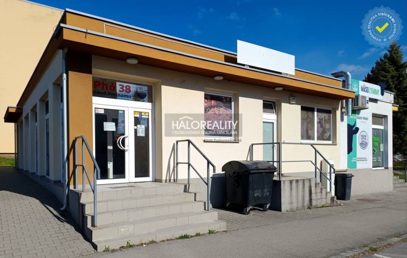 Commercial premises in Žiar nad Hronom with a staircase at the entrance and advertising signs.
