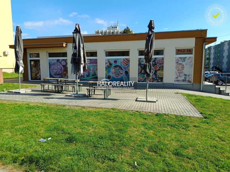 The exterior of commercial premises in Žiar nad Hronom with a terrace and retracted umbrellas.