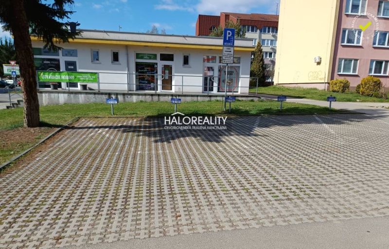 Commercial premises in Žiar nad Hronom with parking on paving, surroundings of buildings.